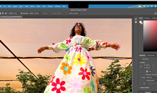 MacBook Air, screen shows an Adobe Photoshop window displaying a photo of a woman in a colorful floral dress, to showcase the brightness of the Liquid Retina display