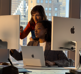People working in an office using several screens at once, to demonstrate that you can connect MacBook Air to external displays