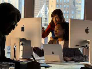 People working in an office using several screens at once, to demonstrate that you can connect MacBook Air to external displays